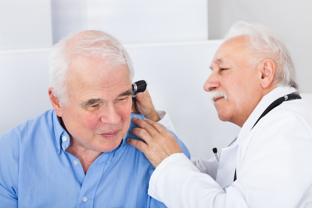 hearing specialist administering diagnostic ear evaluation