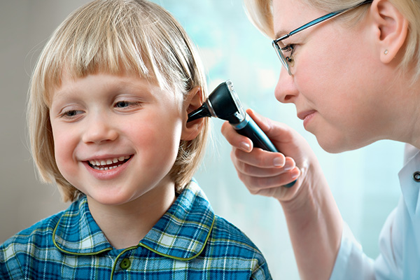 young child receiving hearing examination